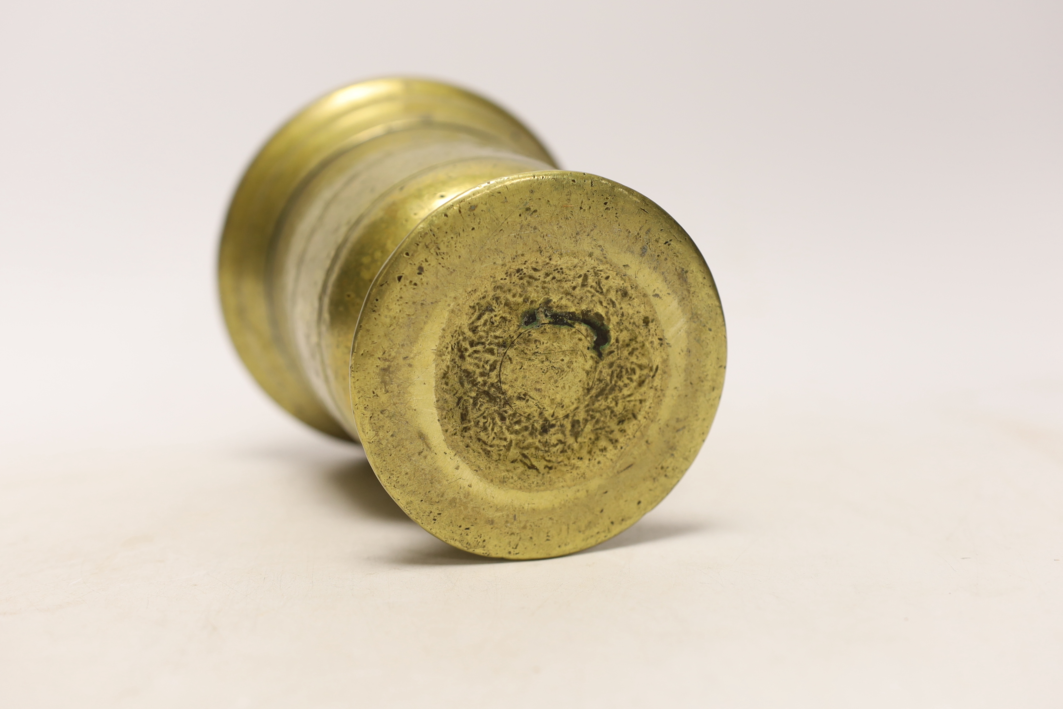 An antique bronze pestle and mortar, 15cm high